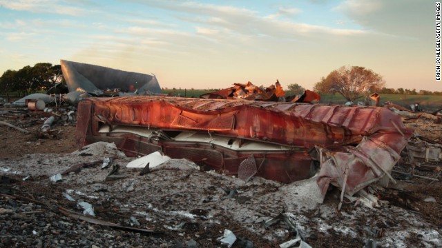 A railroad boxcar lies on its side near the plant on April 18.