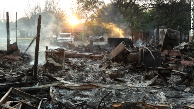 Smoke rises April 18 from the rubble of a house next to the fertilizer plant.