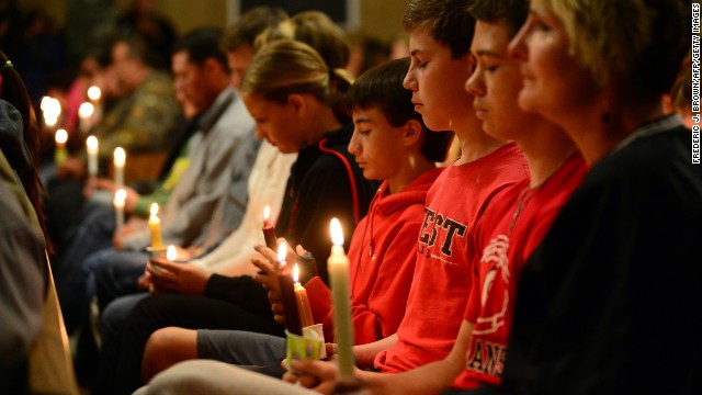 People gather for a candlelight vigil at a church in West on April 18.