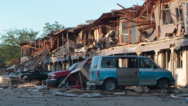 The remains of an apartment complex lie on cars on April 18.