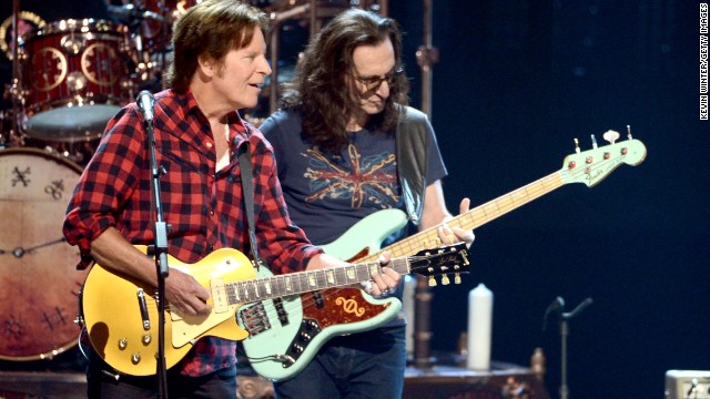 John Fogerty, left, and Rush's Geddy Lee perform together.