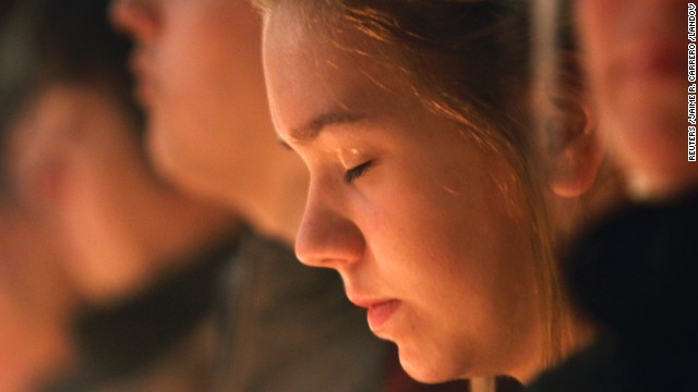 A girl closes her eyes during the vigil. 