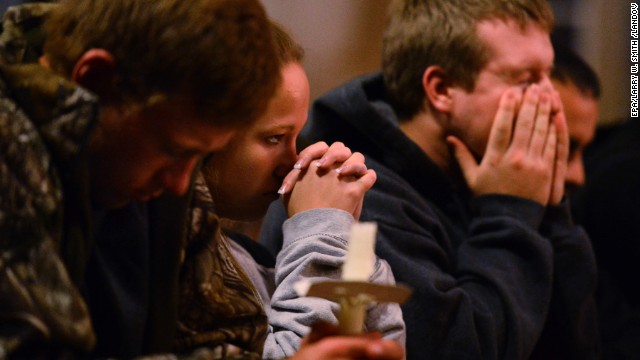 People pray during a candlelight vigil at St. Mary's Church on April 18.