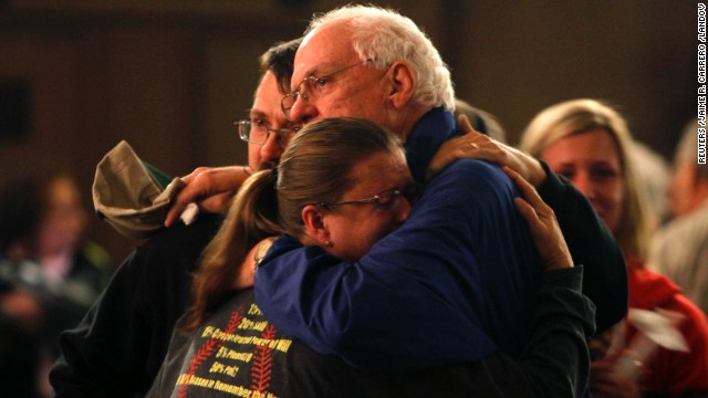 Residents embrace after taking part in the vigil.