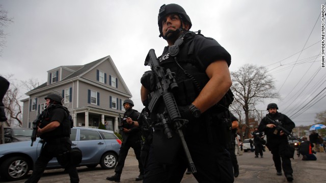 Police officers search house to house for the second suspect in a neighborhood of Watertown, Massachusetts, on Friday. 