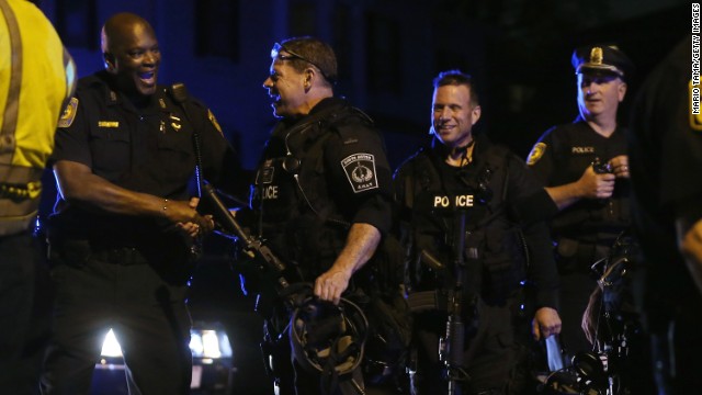 Police officers and SWAT team members exult after the successful operation to capture suspect Dzhokhar Tsarnaev on April 19.