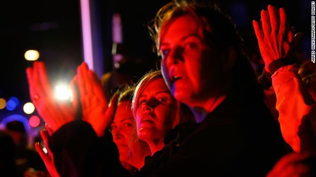 People gather at the scene near Franklin Street in Watertown on April 19.