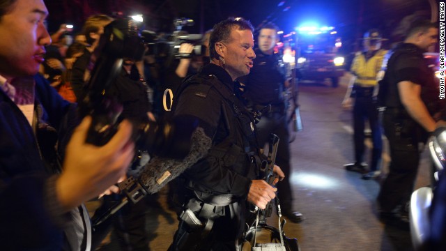 Boston SWAT team members are surrounded by spectators and the media on April 19.