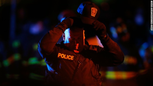 A police officer adjusts his hat while various law enforcement agencies descend on the area around Franklin Street on April 19.