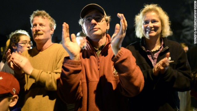 Residents clap after the capture of the second of two suspects wanted in the Boston Marathon bombings on April 19. See all photography relating to the Boston bombings.