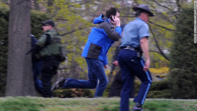 Officers approach an area where a suspect was hiding on April 19.