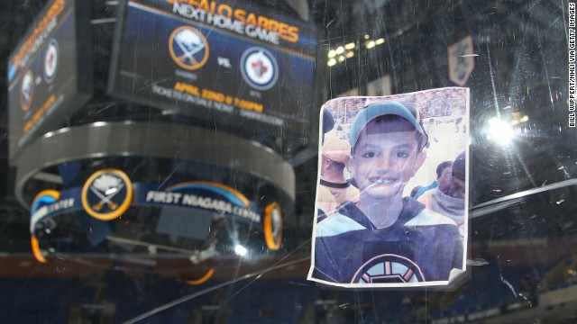 A photograph of Martin Richard, one of the victims of the Boston Marathon bombing, was placed on the plexiglass by a fan following the hockey game between the Buffalo Sabres and the New York Rangers on April 19 at the First Niagara Center in Buffalo, New York. 