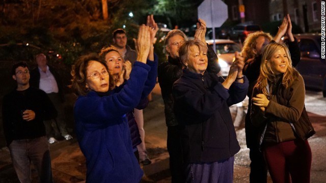 Women cheer police as they exit Franklin Street on Friday, April 19, in Watertown, Massachusetts. 