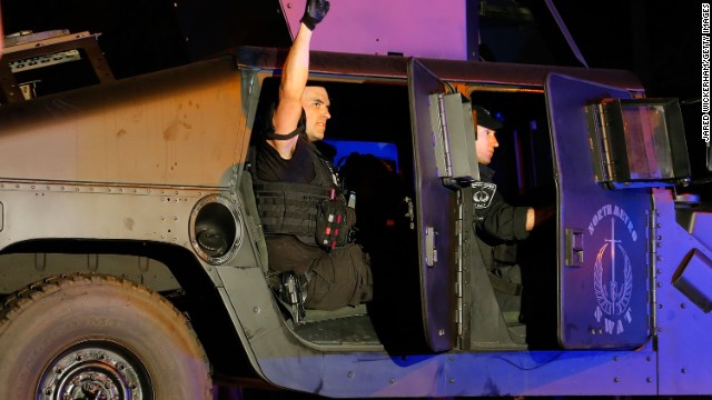 A member of the North Metro SWAT team pumps his fist while leaving the scene near Franklin Street on April 19.