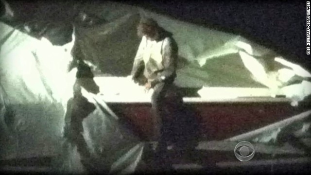 Dzhokhar Tsarnaev gets out of the boat he was hiding in outside of a home in Watertown, as seen in a surveillance video still.