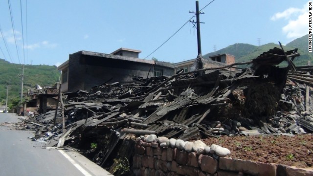 Houses collapsed on the side of a road in Sichuan province.