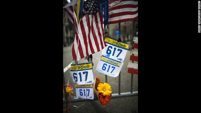 Items hang from a barrier Saturday at the makeshift memorial near the site of the Boston Marathon bombings.