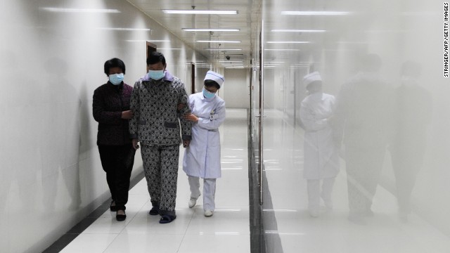 An H7N9 bird flu patient walks in the corridor of a hospital after his recovery and approval for discharge in Bozhou, in central China's Anhui Province, on Friday, April 19. China has reported 83 cases of H7N9 avian influenza. Seventeen people have died from the virus which, while common in birds, hadn't been detected in humans before the first cases were reported in March.