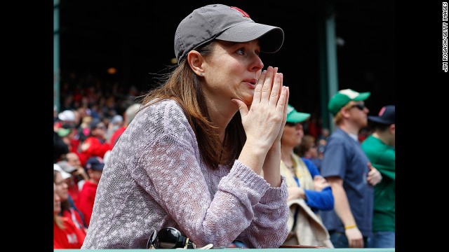 A woman sheds a tear during pregame ceremonies Saturday.