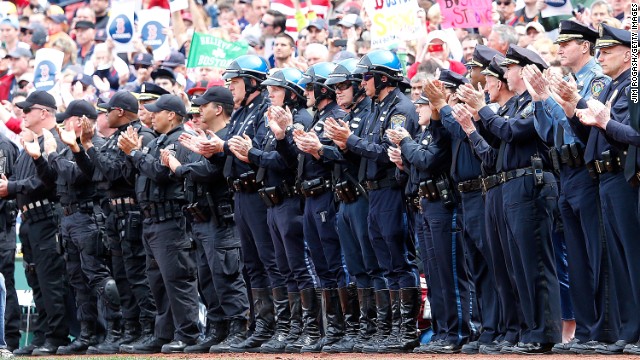 Members of law enforcement react during ceremonies in honor of the Marathon bombing victims before Saturday's game.