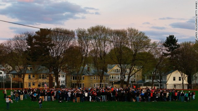 Watertown residents gather to attend a candlelight vigil at Victory Park on April 20.