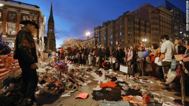 People gather at a makeshift memorial for victims on April 20.