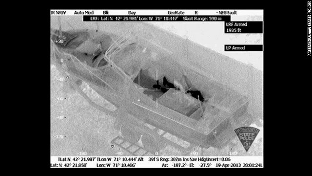 The heat signature clearly shows the suspect's feet and the rest of his body behind the boat console at 8:01 p.m., minutes before he surrendered.