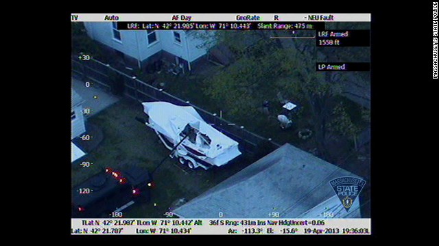 A robotic arm tears away the cover on the boat at 7:36 p.m.