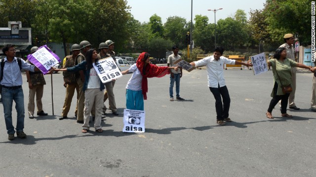 Indian protesters stop traffic in front of police headquarters in New Delhi on Saturday, April 20.