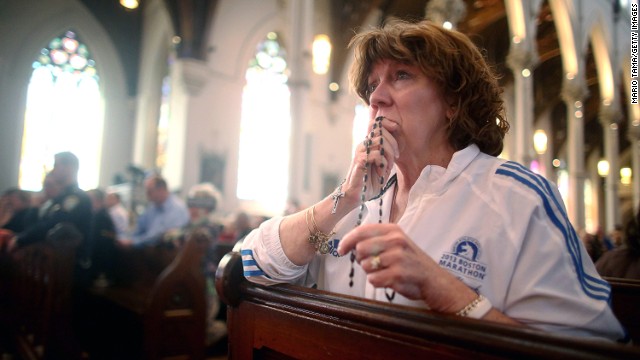 Nurse practitioner Maureen Quaranto, who treated victims of the Boston Marathon bombings, wears her Boston Marathon jacket during Mass at the Cathedral of the Holy Cross on Sunday, April 21, in Boston. The city was working to get back to normal after the capture of the second of two suspects. See all photography related to the Boston bombings.