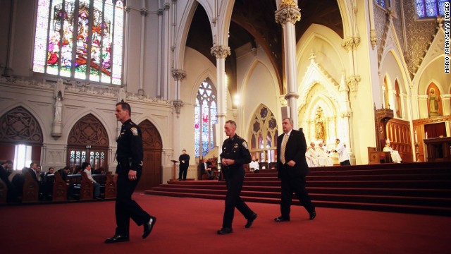 From left, Boston Police Department Superintendents Kevin Buckley and William Evans attend the Mass at the Cathedral of the Holy Cross with Police Commissioner Edward Davis on April 21.