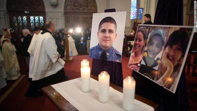 Photos of the deceased are displayed at the Cathedral of the Holy Cross on April 21, the first Sunday since the Boston Marathon bombings.