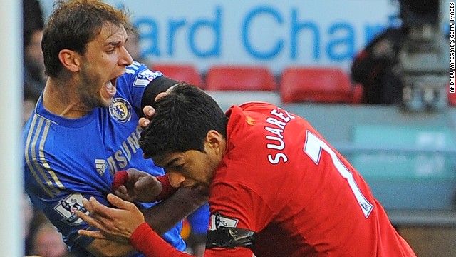 Liverpool striker Luis Suarez (R) clashes with Branislav Ivanovic after appearing to bite the Chelsea player in the second half of Sunday's 2-2 draw.