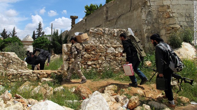 Free Syrian Army fighters take positions prior to an offensive against government forces in the Khan al-Assal area, near Aleppo on Saturday, April 20.