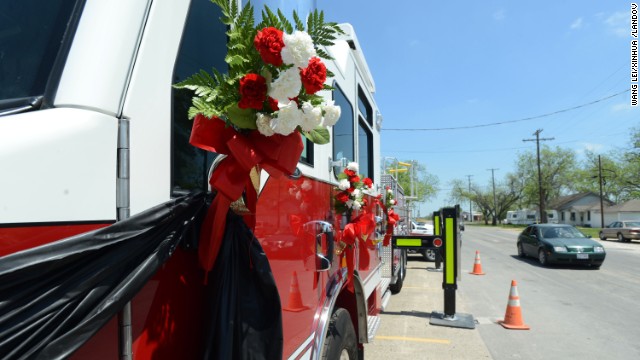 Flowers are tied on a firetruck on April 22 as a memorial for the firemen who died while responding to the explosion.