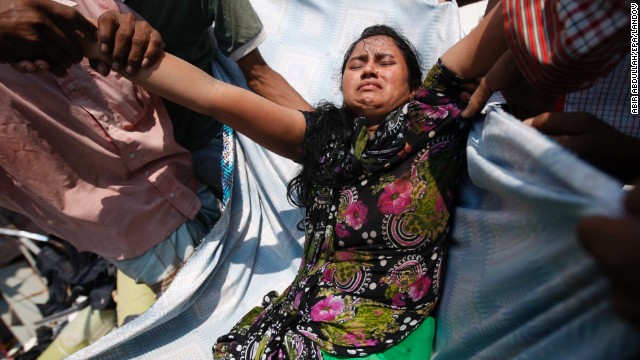 Civilians help an injured garment worker at the Rana Plaza building on the outskirts of Dhaka on April 24. Hundreds were reportedly injured in the collapse.