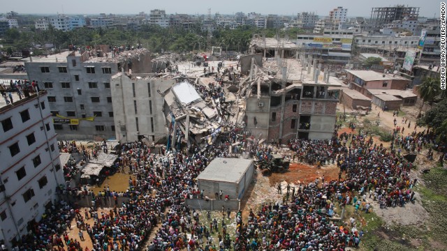 Crowds gather around the collapsed building on April 24.