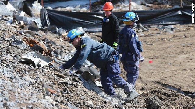 Agents from the Bureau of Alcohol, Tobacco, Firearms and Explosives on April 24 search the bank of rail tracks for evidence at the site of the explosion.