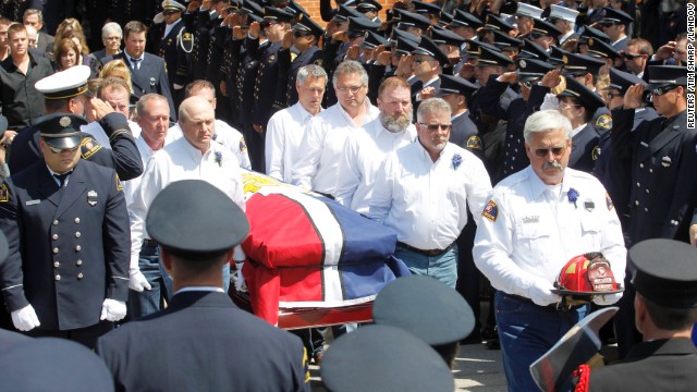 Pallbearers carry the casket of fallen firefighter Capt. Kenneth "Luckey" Harris Jr. after his funeral at St. Mary's Catholic Church of the Assumption in West, Texas, on April 24.