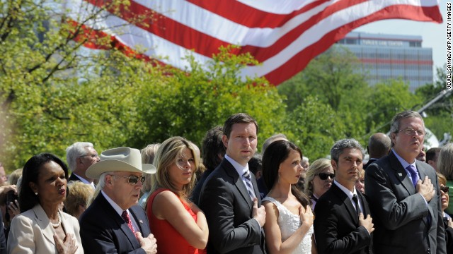 Left to right: former Secretary of State Condoleezza Rice, former Vice President Dick Cheney, Jenna Bush Hager, her husband Henry Hager, Barbara Bush, Miky Febrega, and former Florida Gov. Jeb Bush sing the national anthem at the ceremony.