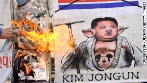 A South Korean burns a caricature of North Korean leader Kim Jong Un at a rally in Seoul on April 18.