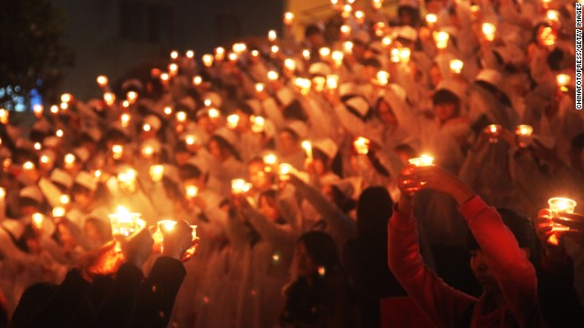 Students of the University of South China light candles to pray for quake victims on April 24 in Hengnan, China.
