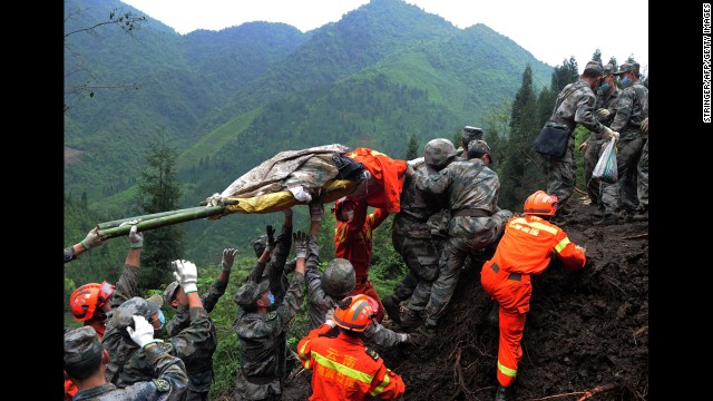 Rescuers carry a victim's body in the Taiping township of Ya'an on April 25.