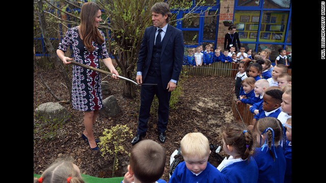 During a visit on April 23 to the Willows Primary School in Manchester, the Duchess plants a willow tree with comedian John Bishop to launch a new school counseling program.