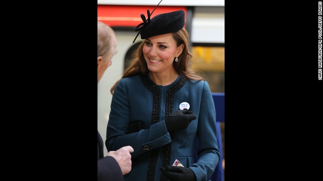 To mark the 150th anniversary of the London Underground on March 20, the Duchess of Cambridge visits the Baker Street Underground Station, wearing a pin that reads, "Baby on Board!"
