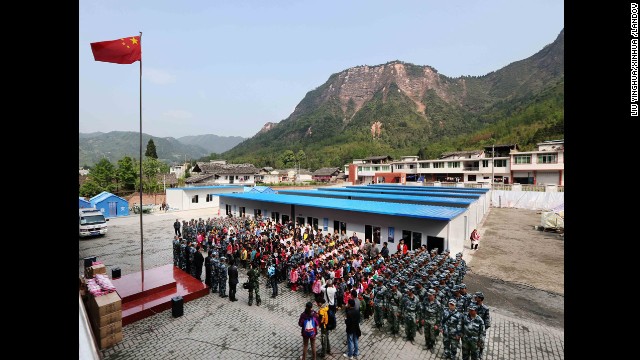 Students and soldiers from the air force attend a flag-raising ceremony in Baosheng Primary School in Lushan County, southwest China's Sichuan province, April 26. The primary school was built within 28 hours by the air force troops from the People's Liberation Army Chengdu Military Area Command, who also donated stationery and computers to students and teachers affected by the earthquake.