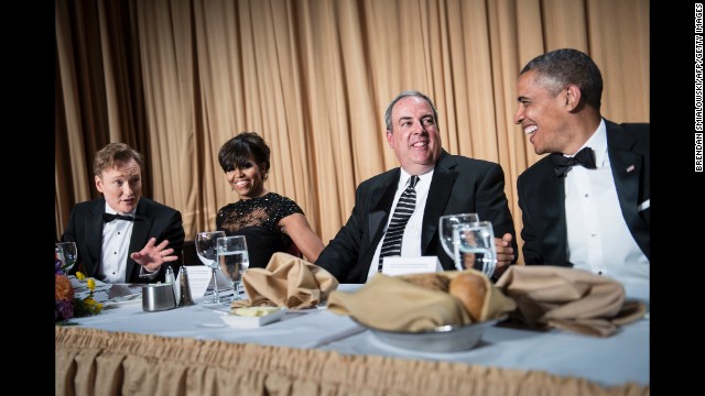 Frst lady Michelle Obama and Michael Clemente of FOX listen as comedian Conan O'Brien and President Barack Obama joke with each other during the night's festivities.