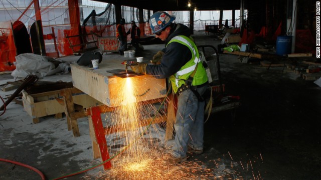 A worker uses a blowtorch to cut metal near the temporary top floor of One World Trade Center on March 9, 2011.