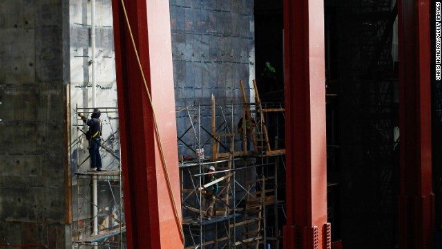 A worker stands on a scaffolding near the base of the construction on December 9, 2010.