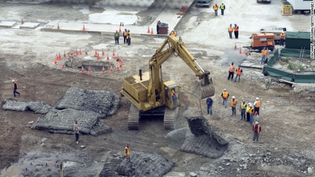 An excavator moves protective mats into position over the hole where test blasts were fired in preparation for the footings of what was then called Freedom Tower on June 12, 2006.